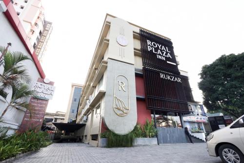 a building with a surfboard on the side of it at Royal Plaza Inn by RAK Rooms, Calicut in Kozhikode