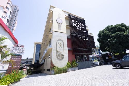 a building with a sign on the side of a street at Royal Plaza Inn by RAK Rooms, Calicut in Kozhikode