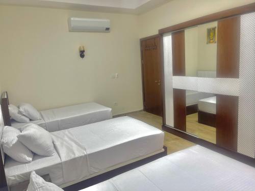 a bedroom with two bunk beds and a mirror at Elegant Apartment with Two Bedrooms in New Alamein in El Alamein