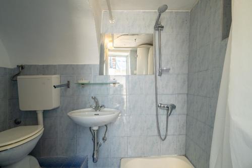 a bathroom with a sink and a toilet and a shower at Apartmán Stašica in Selce