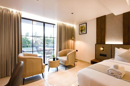 a hotel room with a bed and a balcony at Royal Plaza Inn by RAK Rooms, Calicut in Kozhikode