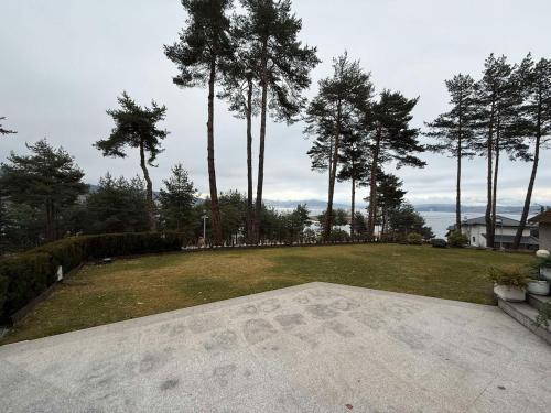 a large yard with trees and a large grass field at Premium Studio Apartment in Private Villa Nisim in Batak