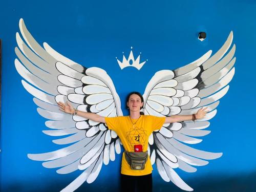 a woman standing with her arms outstretched with a painting of avisor at Tissa Yala Lake View Hotel in Tissamaharama
