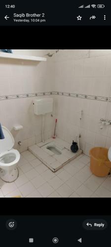 a bathroom with a sink and a toilet at WanderNest BirmiGali in Abbottābād