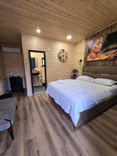 a bedroom with a large white bed in a room at Bella Vista Bungalow in Turda