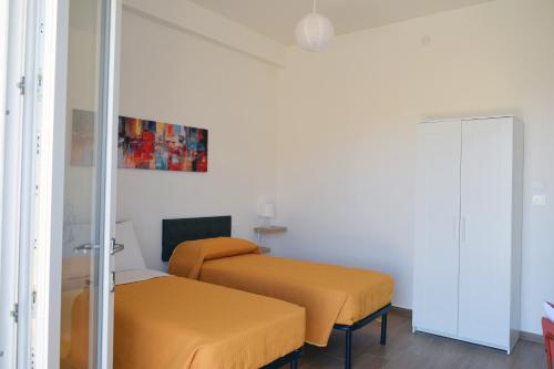 a room with two beds and a mirror at Granatelli Holiday Home in Altavilla Milicia