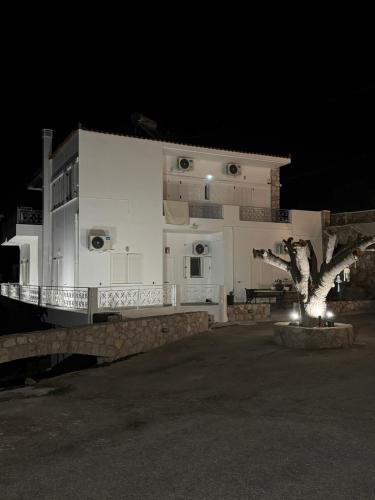 a large white building with a tree in front of it at Agia Anna Horizon in Kranidi