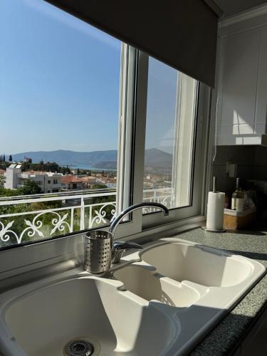 a white sink in a kitchen with a window at Agia Anna Horizon in Kranidi