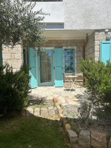 a blue front door of a house with a table at Villa Tre Mari in Villasimius