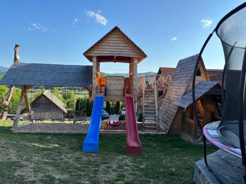 a playground with a gazebo and a slide at Pensiunea Valea Branzei in Năneşti