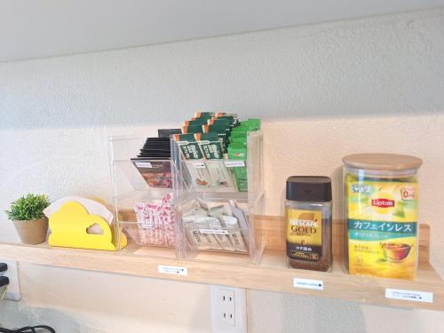 a shelf with food and other items on it at Peaceful Garden Home in Ota, Entire 3BR Parking in Ota