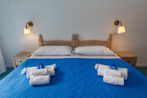a blue bed with towels on top of it at Villa Tre Mari in Villasimius