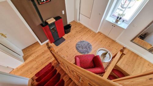 a hammock in a living room with a red chair at Villa Bella Vita in Seeboden