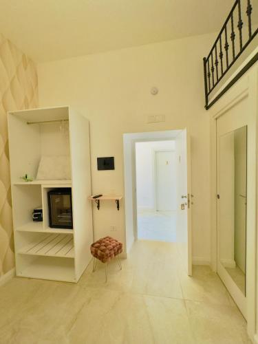 a hallway with a room with a tv and a chair at Villa Romilda in Ascea