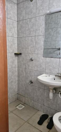 a bathroom with a sink and a mirror at The DeeLight Stay in Nairobi
