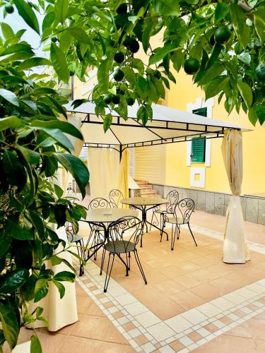a patio with a table and chairs and trees at Villa Romilda in Ascea