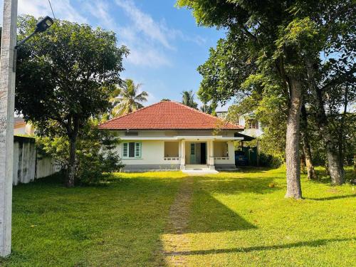 a white house with a red roof at Coastal Getaway in Negombo