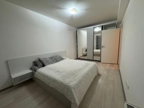 a bedroom with a bed and a large mirror at Avantgarden Studio Brasov in Braşov