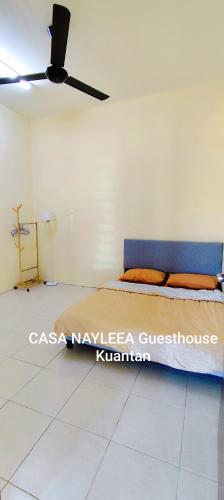 a bedroom with a bed and a ceiling fan at CASA NAYLEEA Guesthouse Kuantan in Kuantan