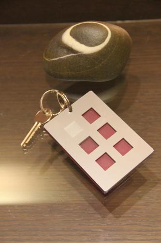 a key chain on a table with a key ring at island in Pefki