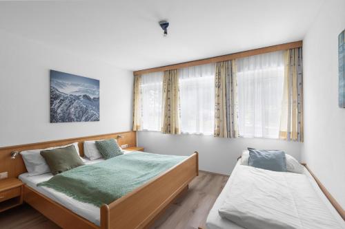 Postel nebo postele na pokoji v ubytování Haus Gletscherblick