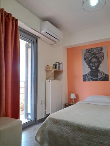 a bedroom with a bed and a large window at Makis rooms A in Mesolongion