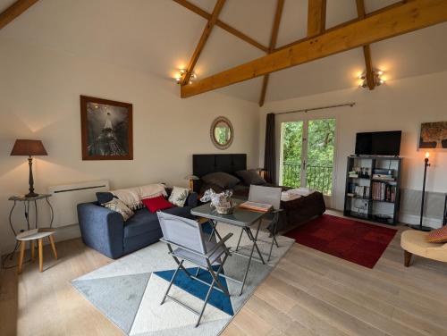 a living room with a couch and a table at La Chesnaie in Bonnes