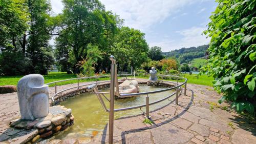 a water fountain with two statues in a park at Villa Bella Vita in Seeboden