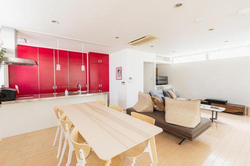 a kitchen and living room with a table and a couch at OASIS HAKATA SUITE 2 Parkings in Fukuoka