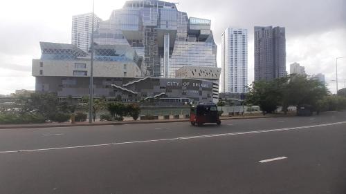 a vehicle driving down a road in a city at The Royal Mount Palace Colombo in Mount Lavinia