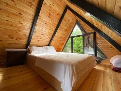 a bedroom with a bed in a room with a window at Opera Bungalov 2 in Ordu