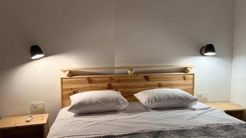 a bedroom with a bed with two white pillows at Kvariati House in Kvariati