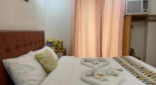 a bedroom with a bed with towels on it at Pilot Hotel in Alaminos
