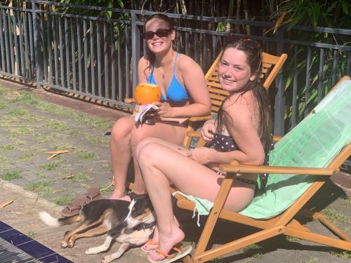 two girls sitting in a chair with a dog at MILLET'S FOOD COMPANY AND COOKING CENTER in Negombo