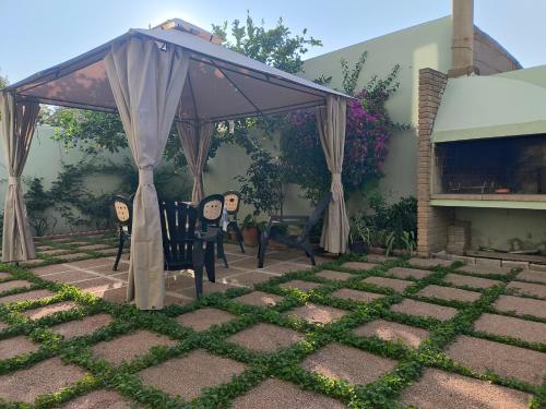 a patio with two chairs under a canopy at Casa vacanze a due passi dal Poetto in Maracalagonis