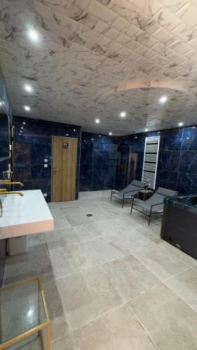 a bathroom with blue tiled walls and a sink at Spa home, Hammam in Prénouvellon