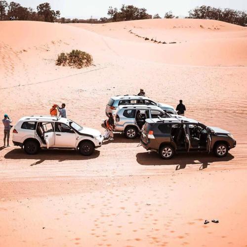 a group of three cars parked in the desert at Sahara Soul luxury Camp in Merzouga