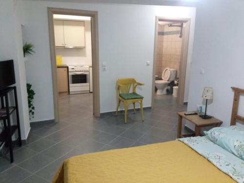 a bedroom with a bed and a kitchen and a bathroom at Makis rooms C in Mesolongion