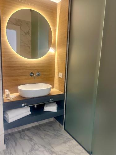 a bathroom with a sink and a mirror at Liberty Palace in Milazzo