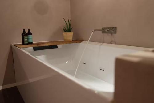 two bottles of wine sitting on a counter in a bathroom at Venice Luxury Suite - Private Jacuzzi and Design in Venice
