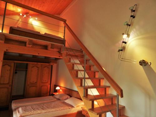 a spiral staircase in a bedroom with a bunk bed at Hotel Königsseer Hof in Schönau am Königssee
