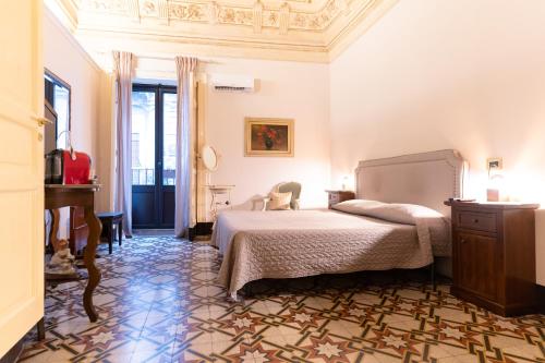 a bedroom with a bed and a piano at Vera Rooms in Catania