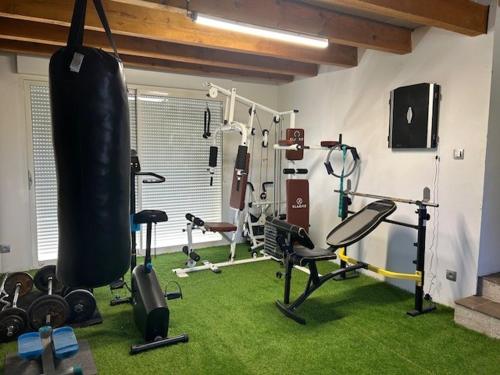 a room with a gym with weights and exercise equipment at Maison idéal Familles nombreuses in Graveson