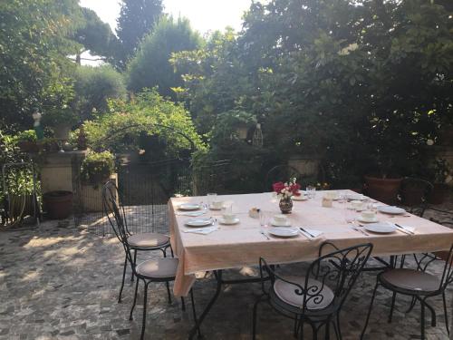 a wooden table and chairs in a garden at B&B Corte delle Muse in San Felice del Benaco