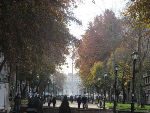 a group of people walking down a city street at Departamento Paseo Bulnes Metro La Moneda in Santiago