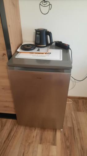 a coffee pot sitting on top of a stove at Penzion a drevenica pri Hati in Terchová