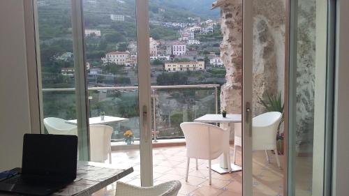a room with a laptop computer on a table and a window at Le Perle d'Italia in Ravello