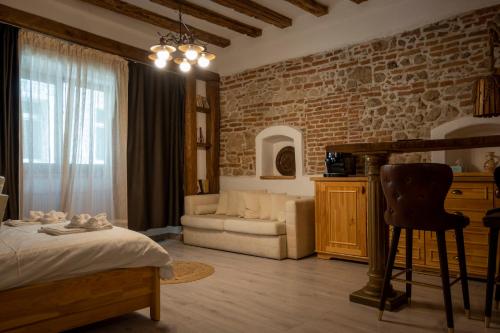 a bedroom with a bed and a brick wall at Boutique 11 Postavarului by Kronstay in Braşov