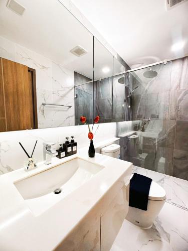 a white bathroom with a sink and a toilet at Astra sky river five star condo in Chiang Mai