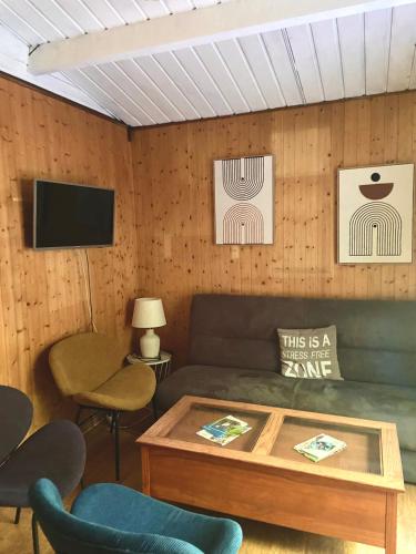 a living room with a couch and a table at Village de vacances oignies in Oignies-en-Thierache